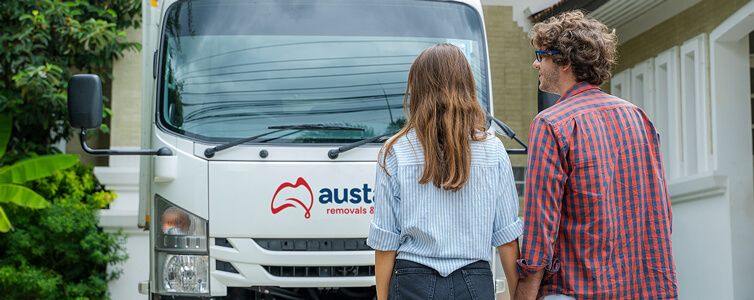 Couple watch as their furniture is delivered by their local removalist team
